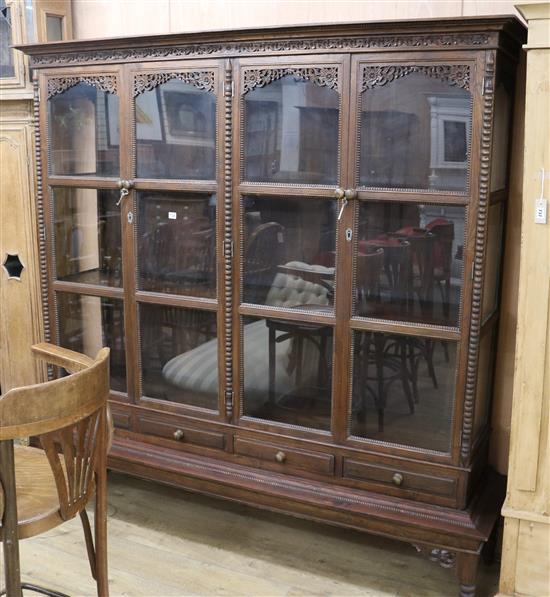 A large carved oak display cabinet W.200cm